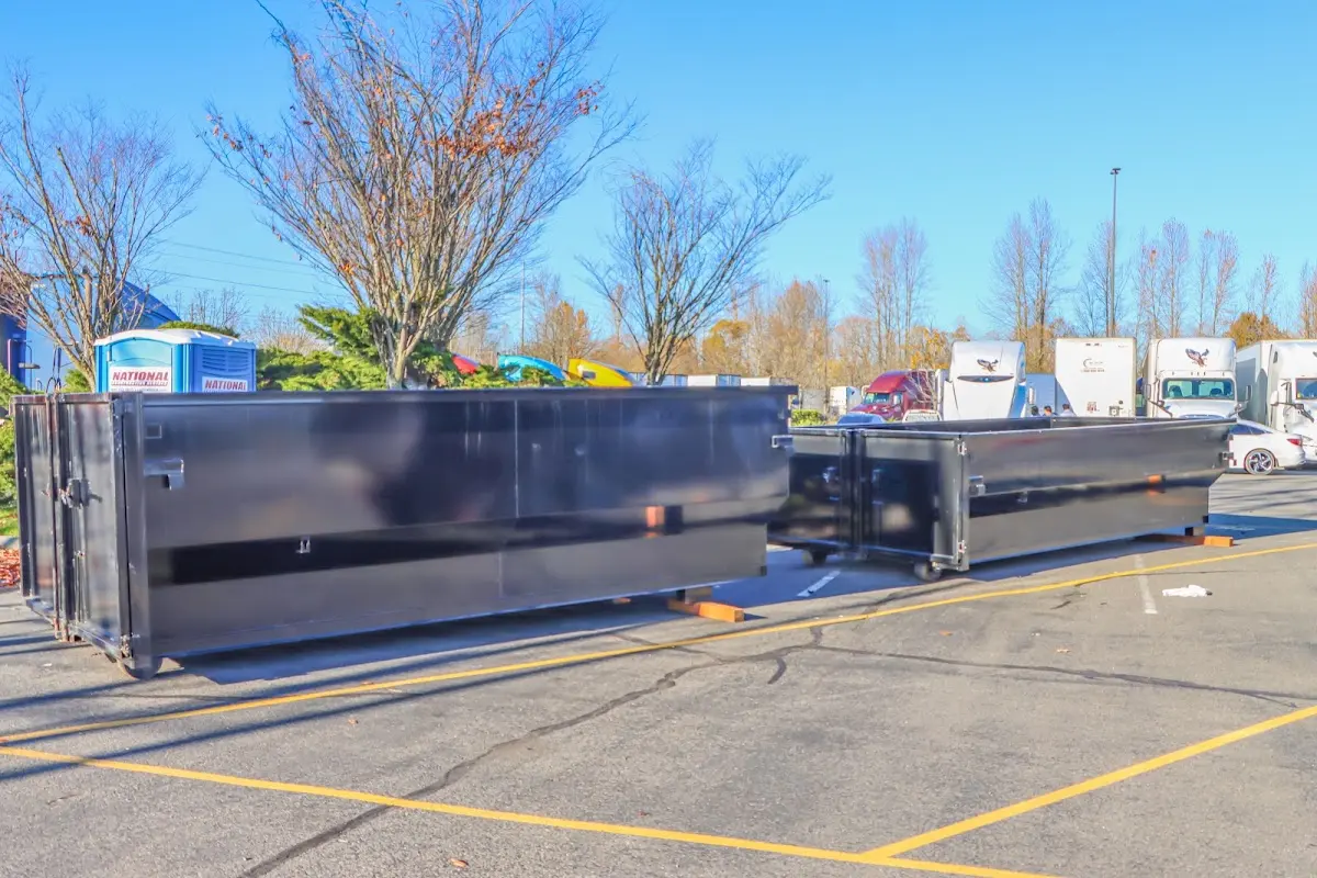 Professional dumpster rental service with roll-off container on residential driveway in Mandeville